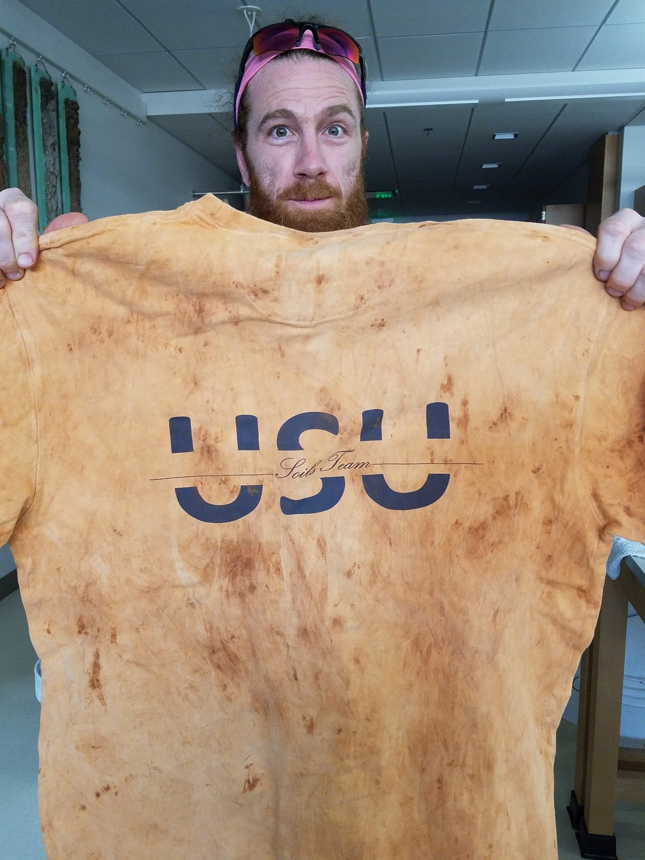 Team member Logan Banner shows off a team t-shirt dyed using soil.