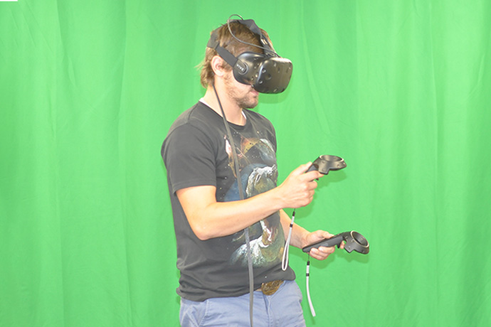 Green screen behind a man in VR