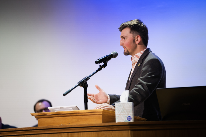 Ryan Bake asks a question at the CAAS forum with U.S. Secretary of Agriculture Tom Vilsack during May 2022 Commencement