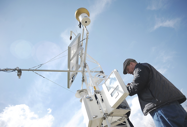 Technician working on weather station